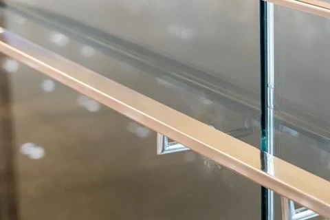Sunlight reflection and bokeh on a modern metal handrail and glass balustrad Fotos Stock