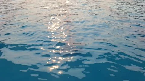 Sunlight Reflection on Calm Blue Water Surface Creating Sparkling Natural B.. Stock Photos