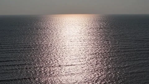Sunlight reflection on calm ocean water surface during golden hour Stock Footage 339802012
