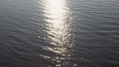 Sunlight Reflection on Calm Water Surface Stock Footage 320334718