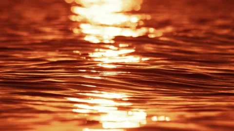 Sunlight reflection shimmering orange water surface closeup beautiful sunset Stock Footage 327518532