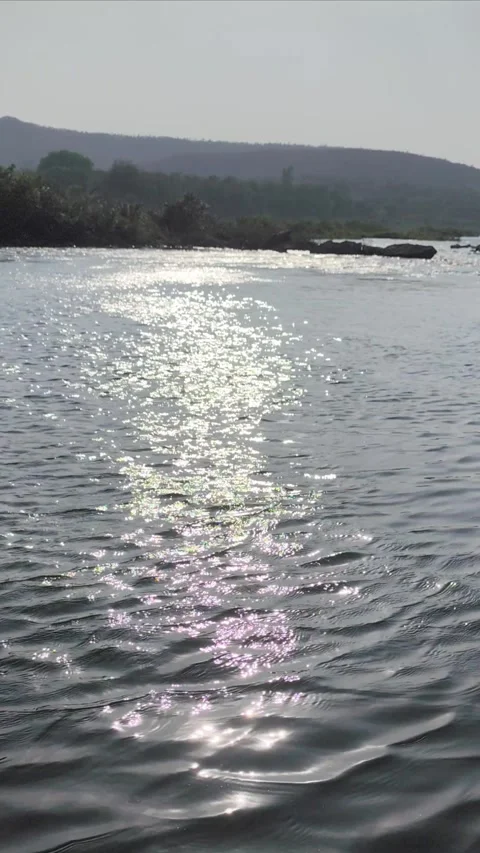 Sunlight Reflection on Water Ripples with Scenic Hills Nature Background. Stock Footage 331080228