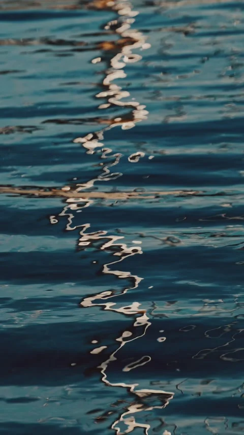 Sunlight reflection on water surface with gentle ripples creating wavy ligh.. Stock Footage 339444207