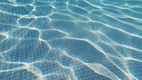 Sunlight Reflections Creating Moving Caustics on Swimming Pool Bottom 動画素材 342326745