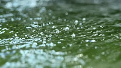 Sunlight reflections on green water in a  pool in the mountains (slow motion) Video stock 211760544