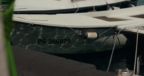 Sunlight Reflections on Moored Boat Hull Stock-Footage 336932400