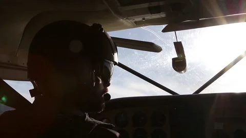 Sunlight reflects behind pilot silhouette Stock Footage 81774087