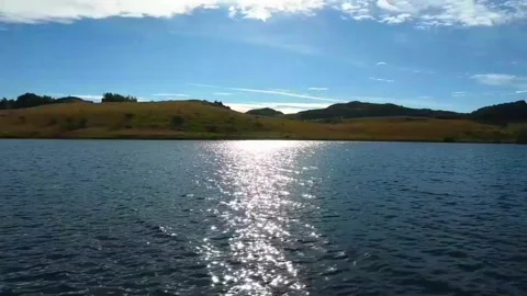 Sunlight reflects on water surface in Norway's landscape during daytime in .. Stock Footage 340211877