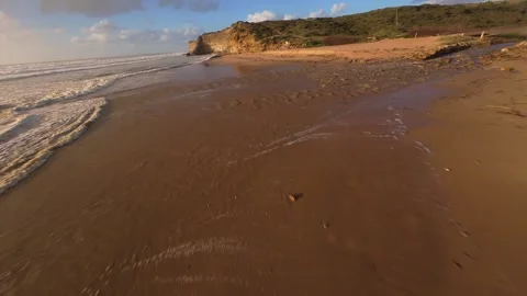 Sunlight reflects on water as waves meet shore Stock Footage 344551210