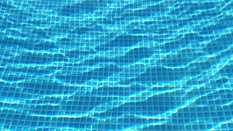 Sunlight Refracting Through Clear Swimming Pool Water Over Grid Pattern Stock Footage 344055391