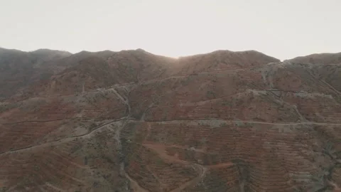 Sunlight Rising Over Hills in Arid Landscape Stock Footage 282931501