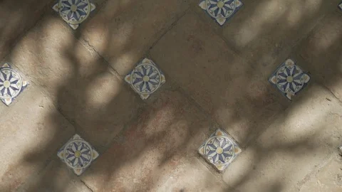 Sunlight / shadows create abstract pattern on tile floor (texture / background) Stock Footage 79484399