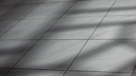 Sunlight Shadows on Tiled Floor Foto stock