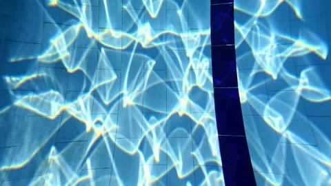 Sunlight Shimmering Through Water onto the Bottom of a Pool Stock Footage 340899113