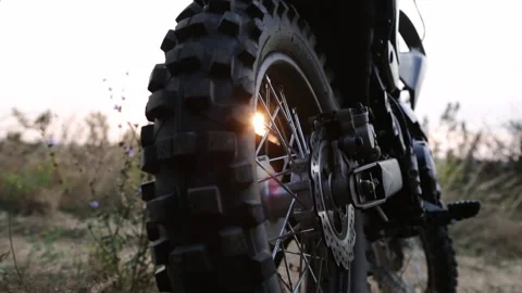Sunlight shine through back wheel of black color cross motorcycle Stock Footage 161315252