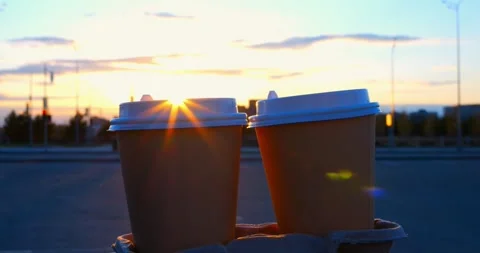 Sunlight shines between two disposable coffee cups on a cardboard tray, creating Stock Footage 309048038