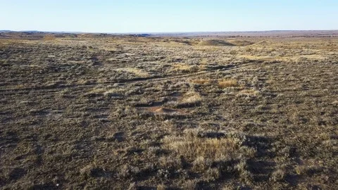 Sunlight shines as drone flies low over sage brush prairie Stock Footage 121386549