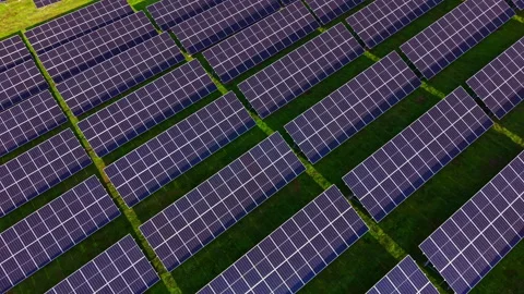 Sunlight shines on endless rows of solar panels creating a tapestry of Stock Footage 331948584