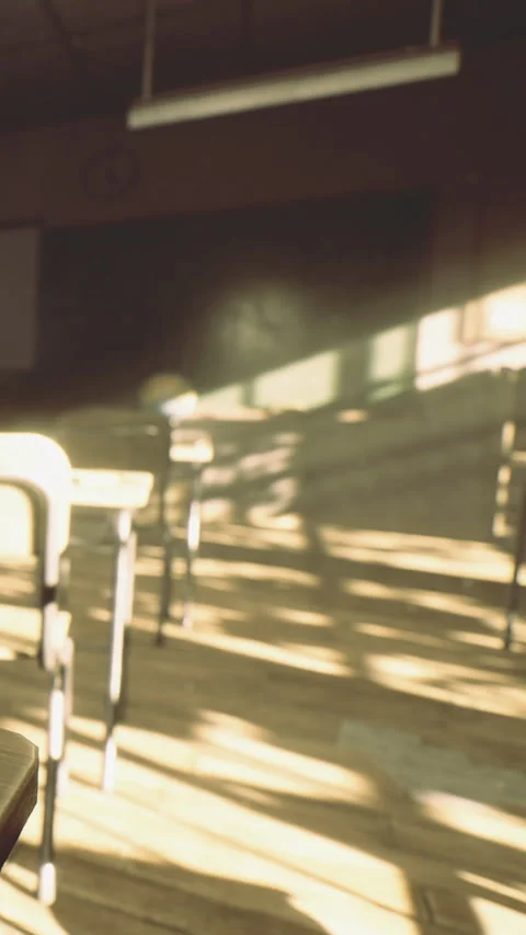 Sunlight shines through a classroom window on empty desks and floors Stock Footage 333567915