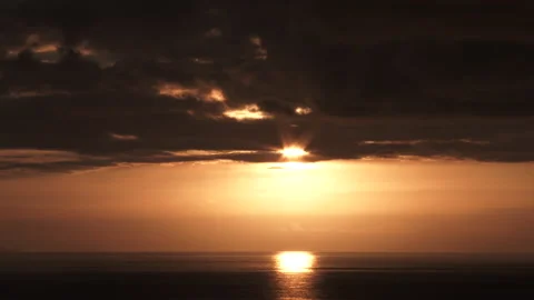 Sunlight Shines Through Clouds Over Body Of Water Video stock 244875502