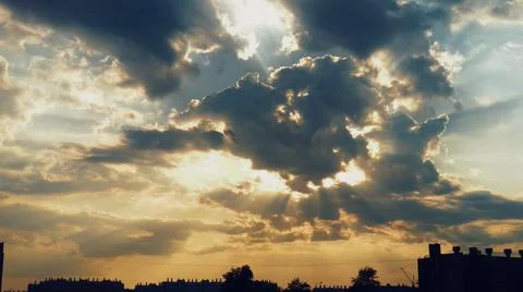 Sunlight shines through a large cloud Stock Photos