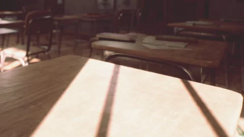 Sunlight shines through window onto empty classroom desks during afternoon Stock Footage 344826361