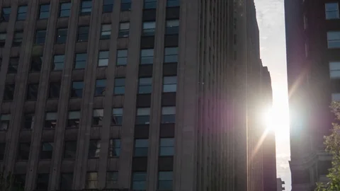 Sunlight Shines Time Lapse Between Buildings In Large City 4K 動画素材 104322072