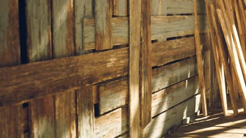 Sunlight shines on wooden planks in a construction area during daytime hours Stock Footage 345064341