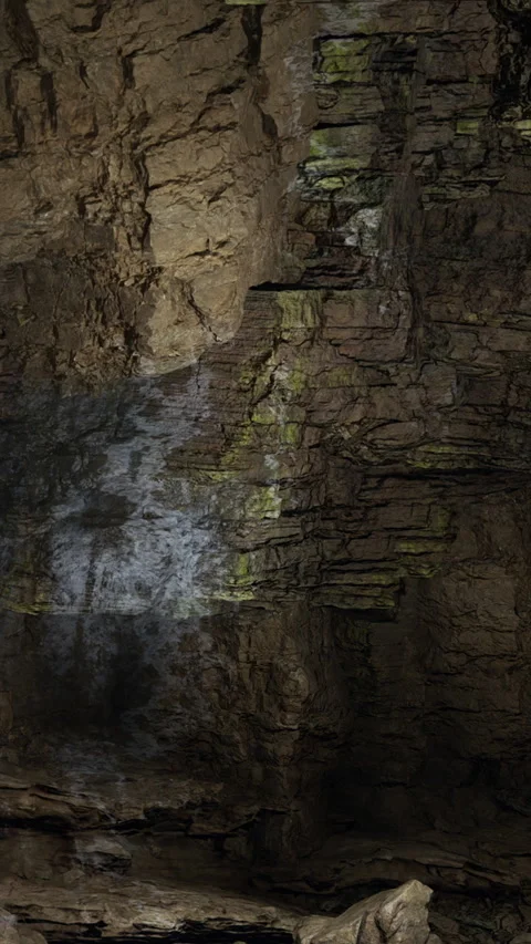 Sunlight shining on a rock wall in a cave during daytime exploration Stock Footage 331750960
