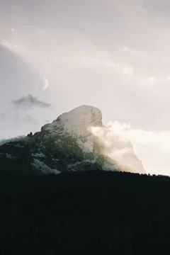 Sunlight shining on the snow covered summit Stock Photos