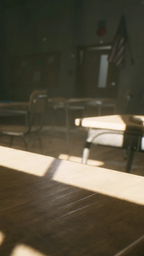 Sunlight shining through classroom windows onto empty desks and chairs Stock Footage 338421575