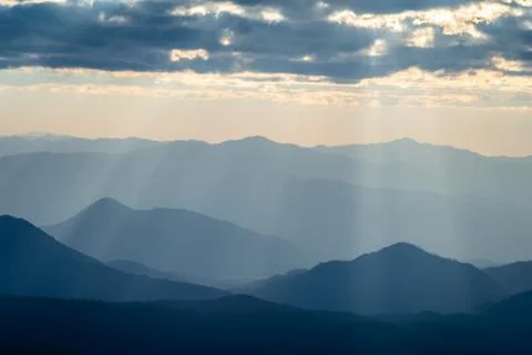 Sunlight shining through clouds to mountain range in Thailand. Stock Photos