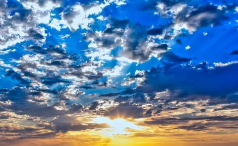 Sunlight Shining Through Clouds Stock Photos