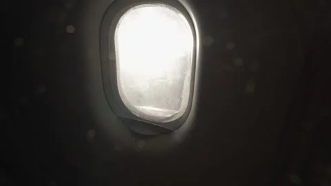 Sunlight shining through dirty airplane window Stock Footage 310190860