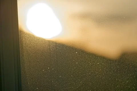 Sunlight shining through a dusty window creating a warm glowing effect Stock Photos