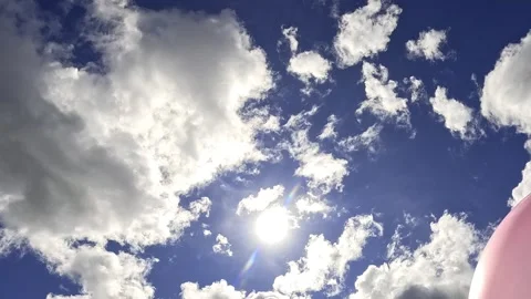 Sunlight shining through moving white clouds in sky Video stock 316329848