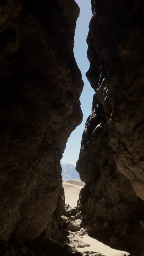 Sunlight shining through rock formations in a desert canyon in the morning Video stock 335689361