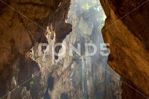 Sunlight shining through the rocks of famous Batu Caves in Kuala Lumpur Stock Photos