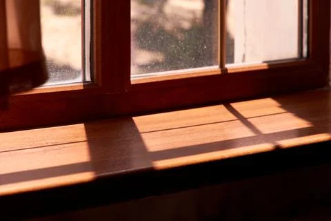 Sunlight shining through the window and shadows on the windowsill Stock Photos