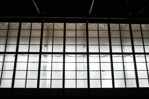 Sunlight shining throuh the windows of an old abandoned industrial warehouse  Stock Photos