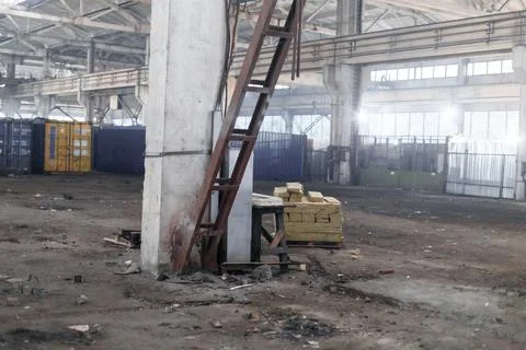 Sunlight shining throuh the windows of an old abandoned industrial warehouse Stock Photos