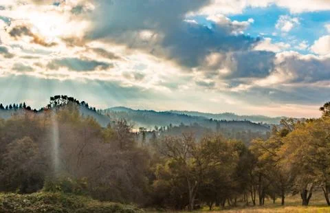 Sunlight Shinning Through the Clouds Stock Photos