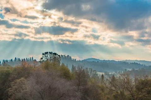 Sunlight Shinning Through the Clouds Stock Photos