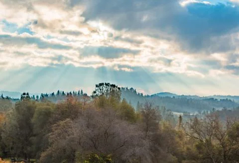 Sunlight Shinning Through the Clouds Stock Photos