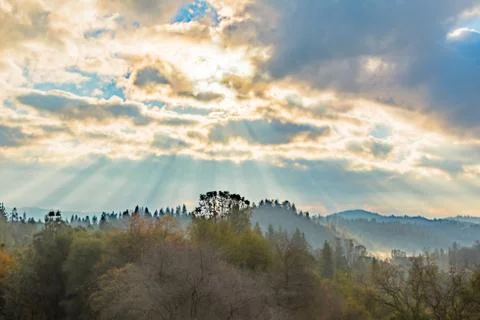 Sunlight Shinning Through the Clouds Stock Photos