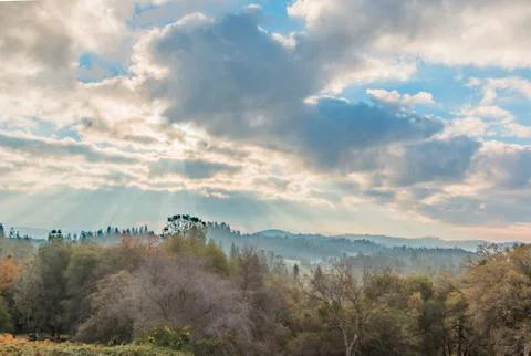 Sunlight Shinning Through the Clouds Stock Photos