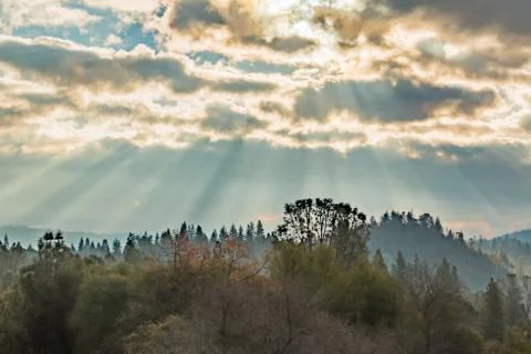 Sunlight Shinning Through the Clouds Stock Photos