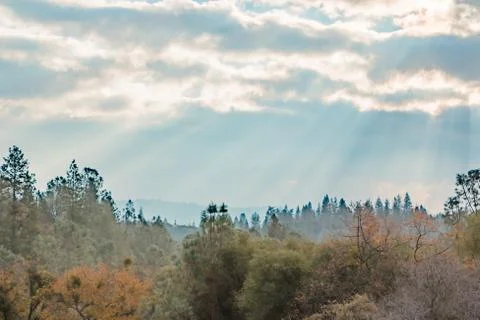 Sunlight Shinning Through the Clouds Stock Photos
