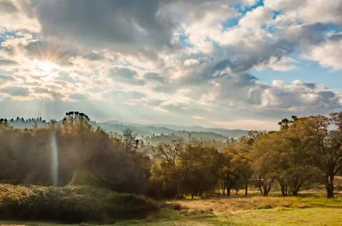 Sunlight Shinning Through the Clouds Stock Photos