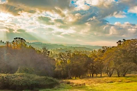 Sunlight Shinning Through the Clouds Stock Photos